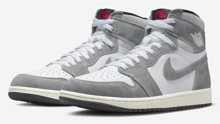 Side view of grey and white Air Jordan sneakers.